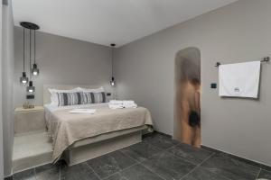 a bedroom with a bed and a bath tub at Uncle's House Junior Suite INDOOR Pool in Adamantas