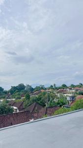 a view of a town with houses and roofs at Mars Homestay Ubud in Ubud