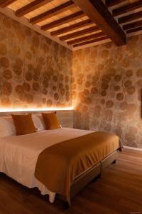 a bedroom with a bed in a room with stone walls at Locanda del lupo in Soragna +75 photos