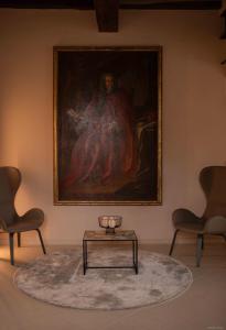a painting on the wall with a table and two chairs at Locanda del lupo in Soragna