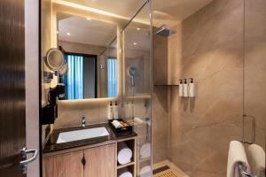 a bathroom with a sink and a shower at Plume Hotels, India Expo Mart, Greater Noida in Greater Noida +39 photos