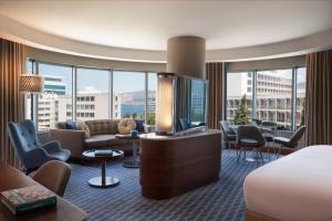 a hotel room with a bed and a living room at Renaissance Izmir Hotel in İzmir