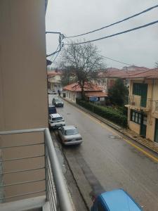 a view from a balcony of a street with cars parked at Super central studio apartment in Kalavrita +1 photo