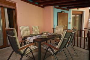 a dining room with a wooden table and chairs at Golden Beach, Gerakini in Gerakini