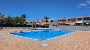 a large swimming pool in a parking lot at Pandora apartment in Las Galletas