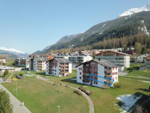a small town with buildings and a mountain at Satin Home in Savognin +3 photos