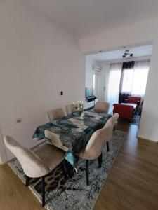 a living room with a dining room table and chairs at Zenith Apartment in Bitola