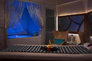 a bedroom with a bed and a tub in a room at Renaissance Izmir Hotel in İzmir +93 photos