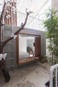 a mirror in a room with a bed and a staircase at Chung Fu Inn in Tainan