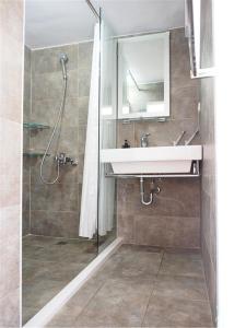 a bathroom with a sink and a shower at Chung Fu Inn in Tainan