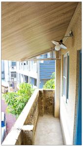 a balcony with a ceiling fan and a window at Chung Fu Inn in Tainan +74 photos