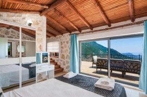 a bedroom with a bed and a balcony with a view at Villa Elvin in Kalkan