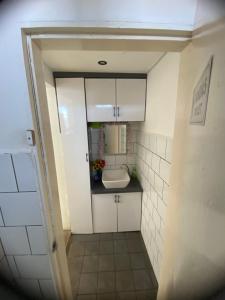 a small bathroom with a sink and white cabinets at AeroHomesuites Tawau in Tawau +17 photos