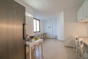 a room with chairs and a table in a room at Domo Le Mura Puniche, nel cuore di Olbia in Olbia +113 photos