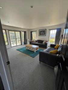 a living room with a couch and a coffee table at City centred living! in Palmerston North