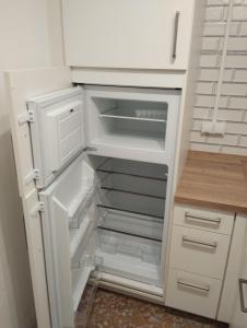 an empty refrigerator with its door open in a kitchen at Ferienhaus check ferien dot world in Berenbach