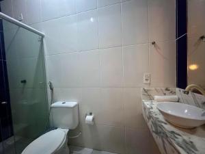 a bathroom with a toilet and a sink at Casa La France in Caucaia +12 photos