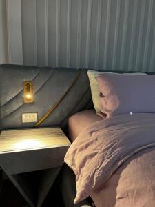 a couch with a light next to a bed at Bicheno getaway for two in Bicheno