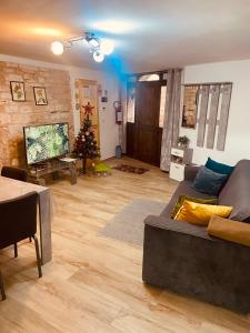 a living room with a couch and a christmas tree at Home Sweet Home in Foligno