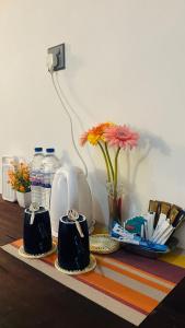 a table with two coffee cups and a vase with flowers at The Hideaway Sigiriya in Sigiriya