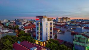 a city skyline with a tall white building at Sky Hotel in Ninh Binh