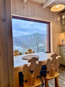a kitchen with a table and a large window at Pod Srebrzystym Świerkiem - Jacuzzi in Koszarawa