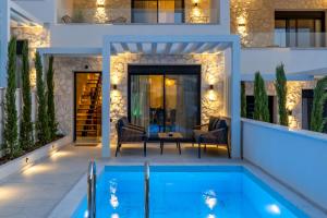 a villa with a swimming pool at night at Kara Villas in Kallithea Halkidikis +32 photos