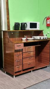 a wooden desk with a microwave on top of it at Dom Hostel in Samarkand