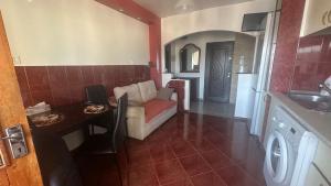 a living room with a couch and a table at 2 Rooms Center Ramnicu Valcea in Râmnicu Vâlcea