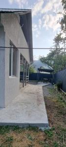 a building with a bench and a picnic shelter at Mia House in Borjomi