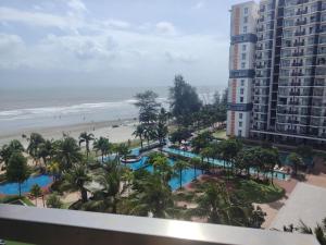 a view of the beach from the balcony of a resort at Timurbay Seafront By Moonlight Sea & Poolview in Kuantan