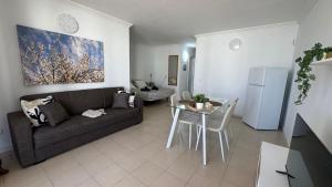 a living room with a couch and a table at Green Park ApartHotel Tenerife in San Miguel de Abona