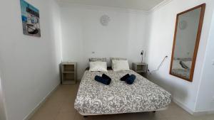 a bedroom with a bed with two pillows on it at Green Park ApartHotel Tenerife in San Miguel de Abona +70 photos
