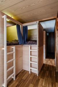 a tiny house with two bunk beds in a room at ゲストハウス nagatafure in Iki