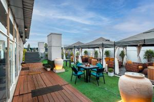 a deck with chairs and tables on a house at Pal Heights Mantra in Bhubaneshwar