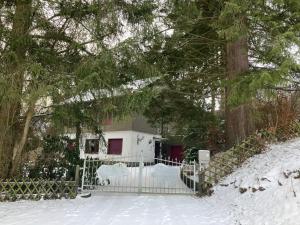 a gate in the snow in front of a house at Ferienhaus-stadtkyll-eifel Beim Förster mit zwei Schlafzimmern in Stadtkyll