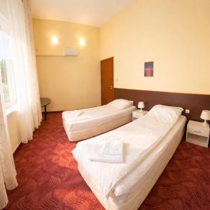 a hotel room with two beds and a window at Комплекс Кремена in Kremena +25 photos