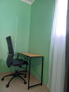 a desk and a chair in a room at The Columbine Couples Suite in Swakopmund