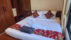 a hotel room with two beds with a bow on them at Pana Villa Koh Lanta in Ban Ai Dao +69 photos