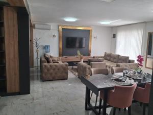 a living room with a couch and a table at Dina lux apartman 2 in Jagodina +10 photos
