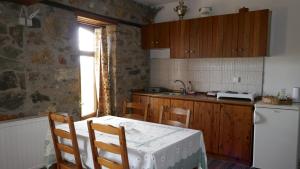 a kitchen with a table and a white table cloth on it at Studio in Elatochori - O Elato in Elatochori +17 photos
