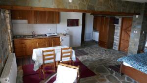 a kitchen with a table and two chairs in it at Studio in Elatochori - O Elato in Elatochori
