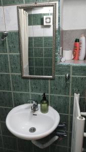 a bathroom with a sink and a mirror at Studio in Elatochori - O Elato in Elatochori