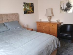 a bedroom with a bed and a chair and a desk at Bideawee in Belton