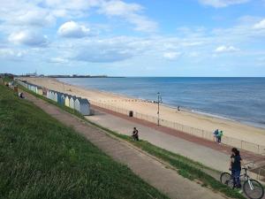 a beach with people walking and a person on a bike at Bideawee in Belton