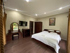 a bedroom with a bed and a sink and a mirror at Resort Botoel at Puncak in Tagalbato +51 photos