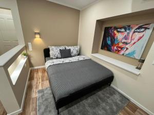 a dog bed in a room with a painting on the wall at Lumio Apartment 3 - Klimatisiert - Coffee for free - in Karlsruhe