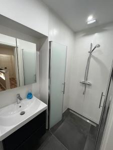 a white bathroom with a shower and a sink at Lumio Apartment 3 - Klimatisiert - Coffee for free - in Karlsruhe