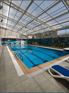 a large indoor swimming pool with a large pool at Badan Suites & Hotel in Amman