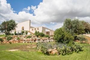 a house on a hill with a stone wall at Agriturismo Spirdo in Ruffano